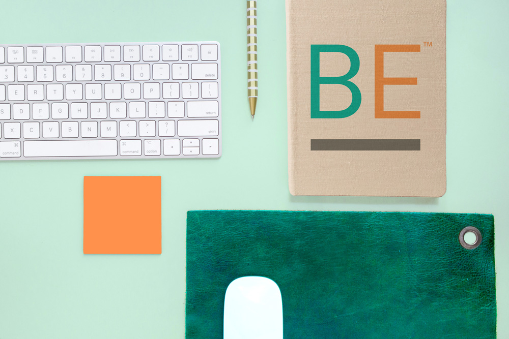 Mockup of keyboard, Boost Engagement branded notebook, notepad, and mouse