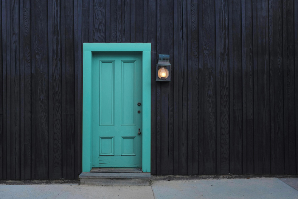 Blue door with light on next to it