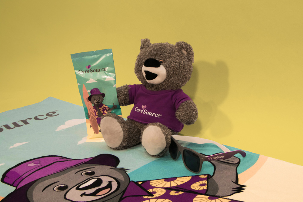 CareSource vacation-themed bear, towel, and sunglasses