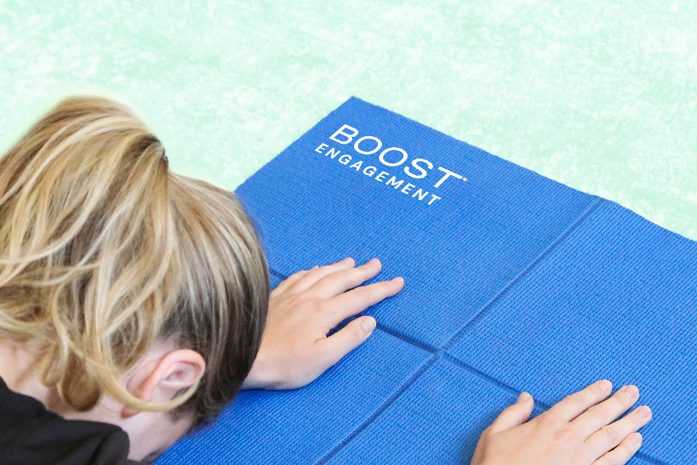 Woman doing yoga on Boost Engagement branded yoga mat