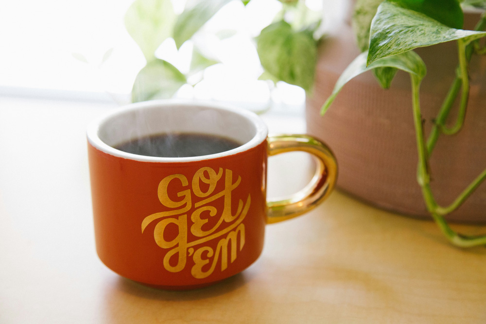 Mug with coffee in it that says "Go Get Em"