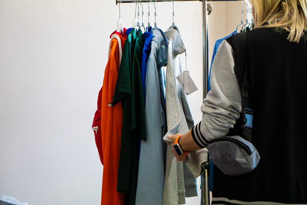 Woman looking through shirts on rack